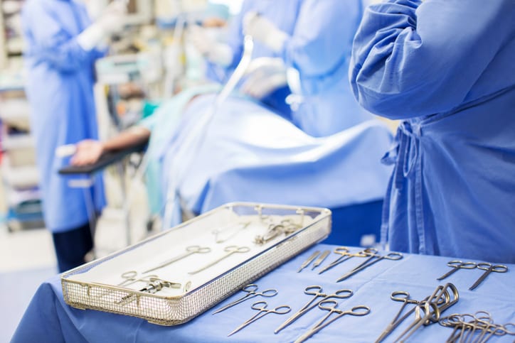 USMS | US Medical Systems | Nurse standing by tray with surgical tools in operating theater